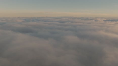 Drone-flight-over-the-clouds-during-a-sunrise