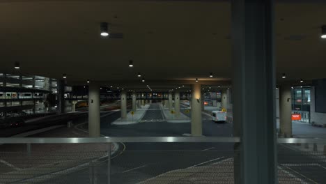 Wide-slider-shot-of-empty-airport-drop-off-lanes-and-parking-garage