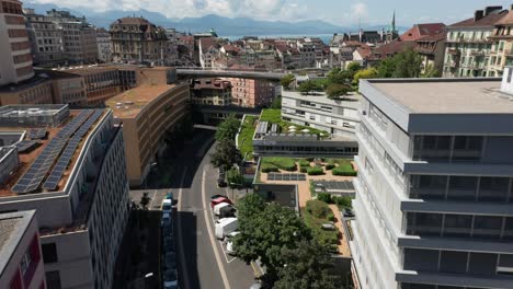 Cinematic-aerial-of-a-building-modern-building-in-downtown-Lausanna,-Switzerland