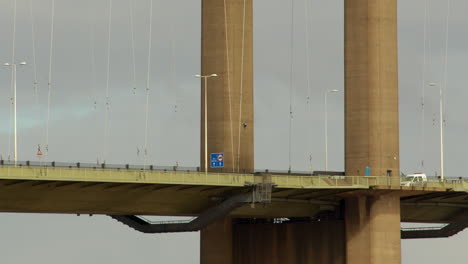 mid-shot-of-traffic-passing-under-the-South-tower-of-the-Humber-bridge-showing-the-maintenance-gantry