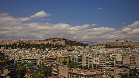Athens,-Greece-in-the-foreground-with-view-of-the-ancient-acropolis-and-Parthenon---time-lapse