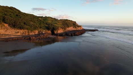 Muriwai-Beach-At-Maukati-Bay-During-Golden-Hour-In-Auckland,-New-Zealand