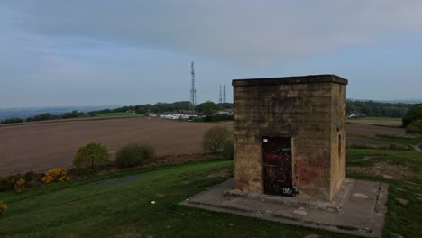 Billinge-hill-beacon-aerial-view-rising-to-reveal-broadcasting-towers-on-Crank-farming-countryside-landmark