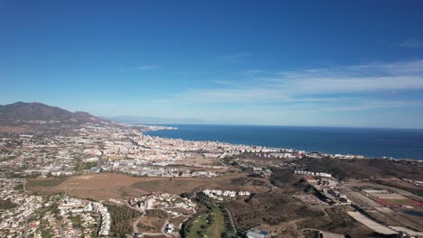 Aerial-view-of-the-cityscape-along-the-coast-at-noon