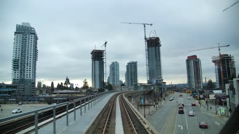 POV-From-SkyTrain-Arriving-At-Burquitlam-Station-With-Condominium-Under-Construction-In-Coquitlam,-Vancouver,-BC,-Canada