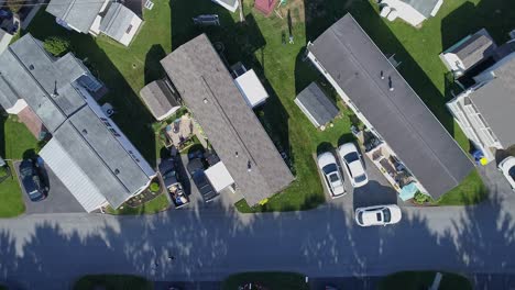 An-Aerial-Down-Looking-View-of-a-Well-Kept-Mobile,-Manufactured,-Prefab-Home-Park-of-Single-Wide-and-Double-Wide-Houses-on-a-Sunny-Day