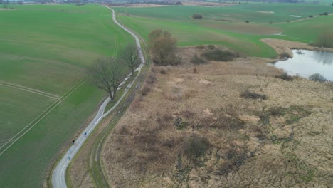 Aerial-View-Over-Country-Road-Between-Agricultural-Fields---Drone-Shot