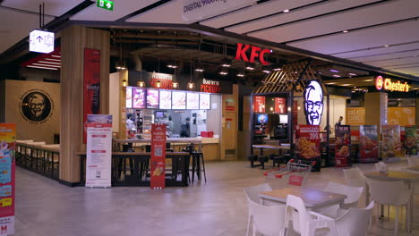 Empty-tables-and-chairs-at-some-fastfood-chains-inside-a-department-store-food-court-located-in-the-middle-of-Bangkok,-Thailand