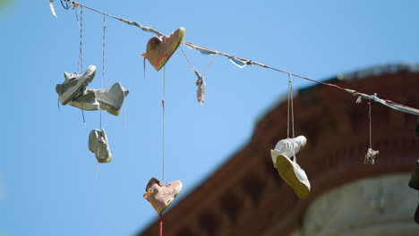 Four-Pair-of-Shoes-Hang-from-Wire-in-Harlem-New-York-City