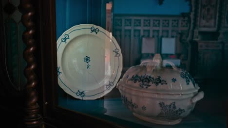 Vintage-ceramic-plate-and-serving-dish-with-floral-patterns-displayed-in-Trakošćan-Castle's-dining-room