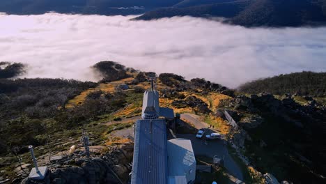 Aerial-of-Thredbo-ski-chairlift-in-summer-with-mountain-cloud-fog,-New-South-Wales,-Australia