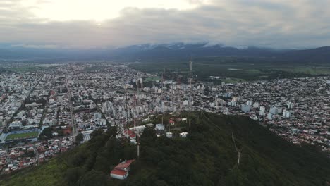 Aerial-Drone-Tracking-Communication-Antennas-On-Mountain-Above-Salta-Capital-City-At-Sunset