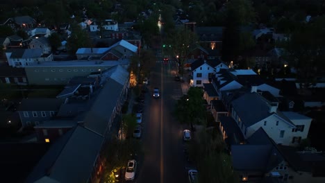 High-aerial-above-town-main-street-at-dusk