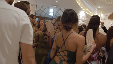 Slow-motion-shot-of-wedding-guests-dancing-to-music-on-the-dancefloor