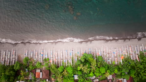 Aerial-panning-right,-rows-of-multiple-Jukung-traditional-fishing-boats