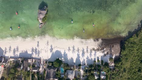 Zanzibar-Beach-Coastline-with-Palm-Tree-Shadow-Silhouettes,-Aerial