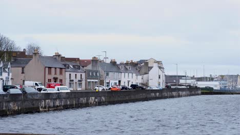View-of-Stornoway-town-with-harbour-and-river-facing-houses-and-parked-cars-in-the-Outer-Hebrides-of-Scotland-UK
