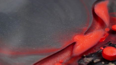 Close-up-of-vibrant-red-ink-spreading-organically-through-water-creating-abstract-patterns