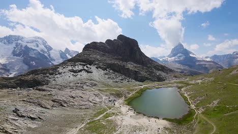 Beautiful-panorama-of-Matterhorn-and-the-Riffelsee-lake-with-the-reflection-and-clouds-in-Swiss-Alps,-Switzerland,-Europe