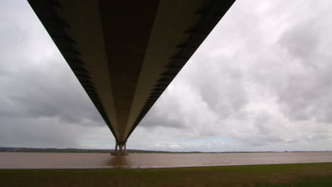 panning-shot-right-to-left,-looking-up-under-the-Humber-bridge-and-stopping-in-the-middle-on-the-south-shore