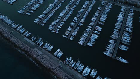 A-crowded-marina-in-menton-near-the-italian-border,-french-riviera,-shot-at-dusk,-aerial-view