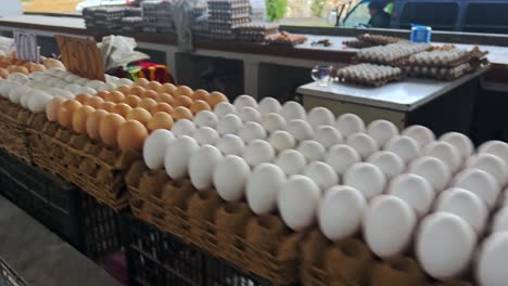 Close-up-organic-eggs-arranged-neatly-stall-at-farmers'-market