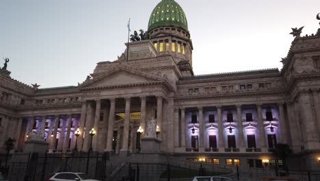 Evening-view-of-the-National-Congress-building-in-Buenos-Aires-with-illuminated-purple-lights-and-a-sunset-backdrop,-close-up