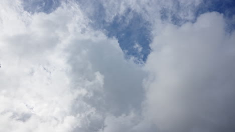 Weite-Aufnahme-Eines-Dynamischen-Himmels-Mit-Ziehenden-Weißen-Wolken-Vor-Einem-Hellblauen-Hintergrund,-Zeitraffer