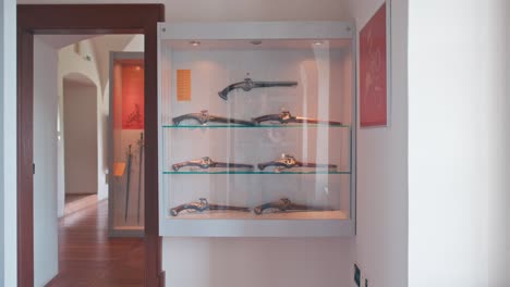 Display-case-of-antique-pistols-in-the-weapon-room-of-Trakošćan-Castle,-Croatia