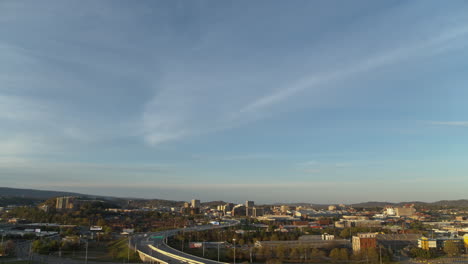 Slow-pan-down-starting-in-the-blue-sky-of-the-sunset-and-revealing-highway-27-and-downtown-Chattanooga,-TN