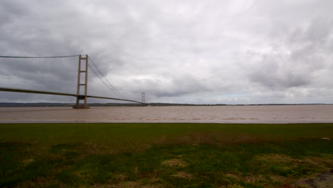 Panning-wide-shots-of-the-Humber-bridge-by-water-side-Road