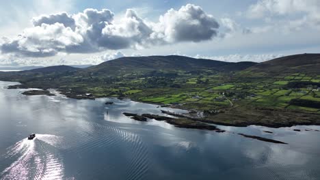 Drone-landscape-of-Bere-Island-west-Cork-Ireland-on-the-Wild-Atlantic-Way-early-morning-with-car-ferry-approaching-the-harbour-popular-tourist-attraction