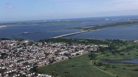 fast-timelapse-of-airplane-landing-at-new-york-airport-with-ocean-and-city-view