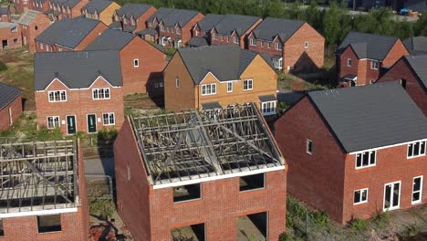 Residential-housing-estate-aerial-view-over-unfinished-property-framework-on-building-development-site-during-recession
