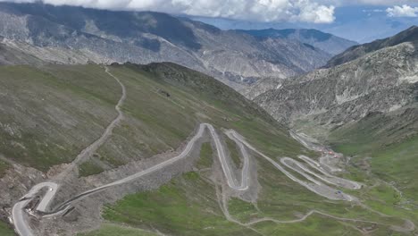 A-drone-retreats-sideways-near-Babusar-Pass,-revealing-the-sweeping-vistas-and-rugged-terrain-of-this-stunning-mountain-pass-in-Northern-Pakistan