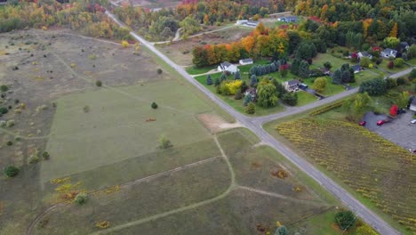 Drone-shows-farmlands-in-the-fall-with-roads-and-houses