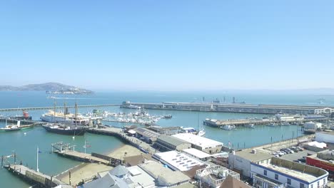 Drone-360-Aerial-Shot-of-San-Francisco-Fisherman's-Wharf,-Ghirardelli-Square,-Aquatic-Cove-and-City