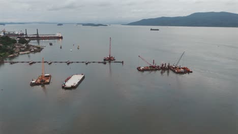 Aerial-view-of-cranes-and-floating-platforms-of-port-of-São-Francisco-do-Sul,-Brazil