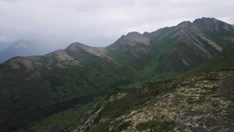 Hiker-Boy-on-Mountain-Pass-in-Alaska-with-Fast-Drone-Reveal