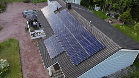 Aerial-overview-of-clouds-reflecting-from-solar-panels-on-a-house-roof