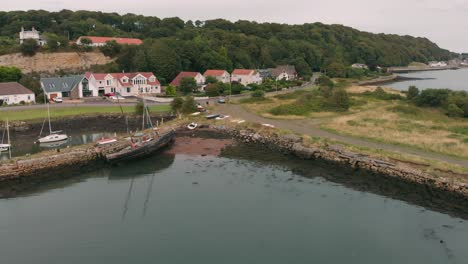 Flying-over-old-broken-ship-in-Charlestown-marina