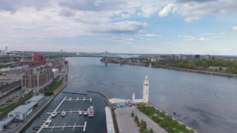 Aerial-footage-of-Montreal-cityscape-with-the-Clock-Tower-and-Jacques-Cartier-Bridge-skyline