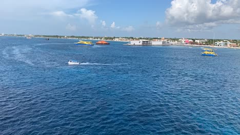 This-is-a-time-lapse-landscape-clip-that-is-of-ferries-moving-around-the-port-in-Cozumel,-Mexico,-in-the-evening-time