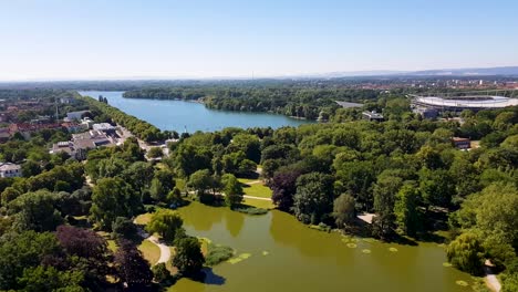 An-aerial-view-of-the-Maschpark-and-Maschsee-in-Hanover,-Germany-on-a-bright-sunny-summer-afternoon
