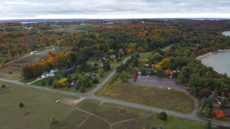 Aerial-shot-of-town-by-the-water-in-the-fall
