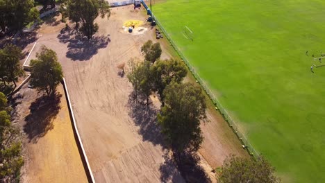 Aerial-pull-back-view-over-all-abilities-play-development-progress,-Riverlinks-Park-Clarkson-Perth