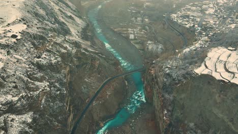 Aerial-Panning-Hunza-River-And-Mountains-Along-Remote-Village---Hunza-Valley