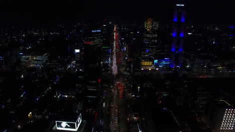 Night-scenery-at-COEX-intersection-in-Seoul,-Samsung-dong,-drone-shot,-tilt-up