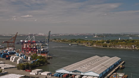 NYC-New-York-Aerial-v207-low-drone-flyover-Waterfront-district-in-Brooklyn-capturing-shoreside-shipyard,-channel-and-views-of-Governors-Island-and-Red-Hook---Shot-with-Inspire-3-8k---September-2023