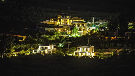 Luxury-modern-villas-with-glowing-night-lights,-time-lapse-view